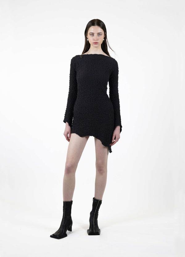 Textured cotton asymmetric dress with stretchy shirring detail, worn by model.